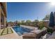 Relaxing backyard features a sparkling pool, a cozy firepit, and ample lounge seating in a private outdoor retreat at 23448 N 76Th Pl, Scottsdale, AZ 85255