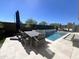 Inviting pool with travertine pavers, patio table, and a seating area that is perfect for outdoor relaxation at 23448 N 76Th Pl, Scottsdale, AZ 85255