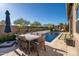 Inviting backyard with a pool, patio dining set, and landscaped lounging area at 23448 N 76Th Pl, Scottsdale, AZ 85255