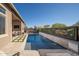 Lush backyard features a sparkling pool, with a cozy firepit, and ample lounge seating and sun exposure at 23448 N 76Th Pl, Scottsdale, AZ 85255