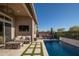 Backyard with a sparkling pool, outdoor seating, a BBQ area, and lush landscaping, perfect for entertaining at 23448 N 76Th Pl, Scottsdale, AZ 85255
