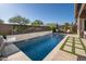 Gorgeous backyard pool featuring an integrated waterfall feature and a lush landscaping design at 23448 N 76Th Pl, Scottsdale, AZ 85255