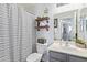 Small bathroom with shower and striped shower curtain at 23625 N El Frio Ct, Sun City, AZ 85373