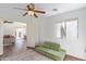 Bedroom with view into living room and green couch at 23625 N El Frio Ct, Sun City, AZ 85373