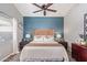 Bright bedroom with wood accent wall and ceiling fan at 23625 N El Frio Ct, Sun City, AZ 85373