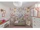 Bedroom with floral wall mural, crib, and dresser at 23625 N El Frio Ct, Sun City, AZ 85373