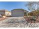 Single-story home with a two-car garage and desert landscaping at 23625 N El Frio Ct, Sun City, AZ 85373