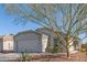 Single-story home with a garage and mature tree in front at 23625 N El Frio Ct, Sun City, AZ 85373