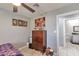 Bedroom with dresser, view of another bathroom, and neutral walls at 2641 W Wethersfield Rd, Phoenix, AZ 85029