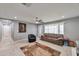 Living area with tiled floors, comfy couch, and a ceiling fan at 2641 W Wethersfield Rd, Phoenix, AZ 85029