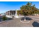 Mobile home with carport, mature landscaping, and a covered porch at 2650 W Union Hills Dr # 108, Phoenix, AZ 85027