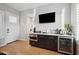 Entertainment bar area features a beverage fridge, wine storage, microwave, and dark wood cabinets with white countertop at 2752 E Pelican Ct, Gilbert, AZ 85297