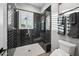 Contemporary bathroom with glass-enclosed shower, white hexagon tile flooring, and black subway tile walls at 2752 E Pelican Ct, Gilbert, AZ 85297