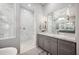 Bright bathroom featuring a large vanity area and a shower with white marble tile and modern fixtures at 2752 E Pelican Ct, Gilbert, AZ 85297