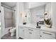 Bathroom with white vanity, quartz countertop, large mirror, and shower-tub combo with gray tile surround at 2752 E Pelican Ct, Gilbert, AZ 85297