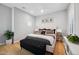 Serene bedroom with light gray walls, hardwood floors, king-size bed, and stylish black accents at 2752 E Pelican Ct, Gilbert, AZ 85297