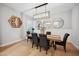 Modern dining room with a rustic wood table, seating for six, and decorative round mirrors at 2752 E Pelican Ct, Gilbert, AZ 85297