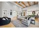 Bright living room with wood beam ceiling, hardwood floors, and a view of the home's entry at 2752 E Pelican Ct, Gilbert, AZ 85297