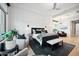 Modern main bedroom featuring a large bed, sitting area, wood floors and bright natural light at 2752 E Pelican Ct, Gilbert, AZ 85297