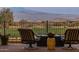 Patio furniture with fire pit overlooking a golf course and mountains at 29215 N Horton Creek Trl, Rio Verde, AZ 85263