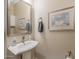 Small powder room with pedestal sink and framed art at 29215 N Horton Creek Trl, Rio Verde, AZ 85263