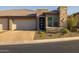 Tan two-car garage home with stone accents and landscaping at 29215 N Horton Creek Trl, Rio Verde, AZ 85263