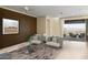 Well-lit living room with neutral tones and a view through sliding doors to an outdoor patio area at 29215 N Horton Creek Trl, Rio Verde, AZ 85263