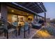 Evening view of patio with seating and fire pit at 29215 N Horton Creek Trl, Rio Verde, AZ 85263