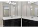 Double vanity bathroom with dark brown cabinets at 29402 W Mitchell Ave, Buckeye, AZ 85396