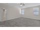 Spacious primary bedroom with carpet flooring and hallway access at 29402 W Mitchell Ave, Buckeye, AZ 85396