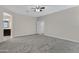 Primary bedroom with carpet flooring, ceiling fan and ensuite bathroom at 29402 W Mitchell Ave, Buckeye, AZ 85396