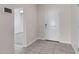 Clean entryway with tile floor, white door, and view to a carpeted room at 29402 W Mitchell Ave, Buckeye, AZ 85396