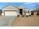 Single-story house with gray exterior, two-car garage, and landscaped front yard at 29402 W Mitchell Ave, Buckeye, AZ 85396