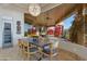 Elegant dining area with mountain views, featuring a unique chandelier and modern furnishings at 29600 N 106Th N Pl, Scottsdale, AZ 85262