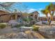 Landscaped front yard with desert plants and a stone bench at 29600 N 106Th N Pl, Scottsdale, AZ 85262