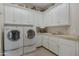 Bright laundry room with ample cabinet space and a side sink at 29600 N 106Th N Pl, Scottsdale, AZ 85262