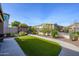 Landscaped backyard with pergola, artificial turf and seating area at 29606 N 21 Dr, Phoenix, AZ 85085