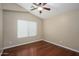 Bright bedroom with hardwood floors and ceiling fan at 29606 N 21 Dr, Phoenix, AZ 85085