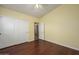 Well-lit bedroom featuring wood floors and spacious closet at 29606 N 21 Dr, Phoenix, AZ 85085