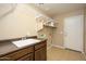 Laundry room with built-in shelving and a utility sink at 29606 N 21 Dr, Phoenix, AZ 85085