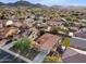 Aerial view of the house showing surrounding neighborhood and desert mountain views at 29762 N 69Th Ln, Peoria, AZ 85383