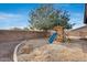 Backyard playground with tree and partial view of block wall at 29762 N 69Th Ln, Peoria, AZ 85383