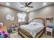 Cozy bedroom with ceiling fan, dresser, and built in closet at 29762 N 69Th Ln, Peoria, AZ 85383