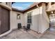 Small paved courtyard with two chairs and view of house entrance at 29762 N 69Th Ln, Peoria, AZ 85383