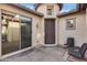 View of a house's entrance with a sliding glass door and small sitting area at 29762 N 69Th Ln, Peoria, AZ 85383