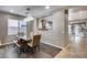 Bright dining room features a spacious table and bench with a modern chandelier at 29762 N 69Th Ln, Peoria, AZ 85383