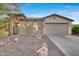 Front view of a charming one-story home with stone accents and a two-car garage at 29762 N 69Th Ln, Peoria, AZ 85383