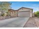 Front view of a house with a large two car garage and stone accents at 29762 N 69Th Ln, Peoria, AZ 85383