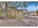 A charming house with stone exterior, a gated entry, and mature landscaping at 29762 N 69Th Ln, Peoria, AZ 85383