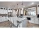 Elegant kitchen features white cabinets, a large island with seating, and wine cooler at 29762 N 69Th Ln, Peoria, AZ 85383